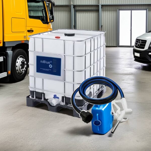 mounted to an IBC tank placed on a clean concrete depot floor, with a bright industrial warehouse background, soft natural light from the left, subtle shadow under the pump and nozzle